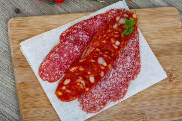 Salami sausage on the wood background — Stock Photo, Image