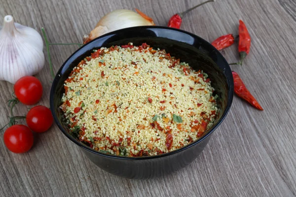 Raw couscous in the bowl — Stock Photo, Image