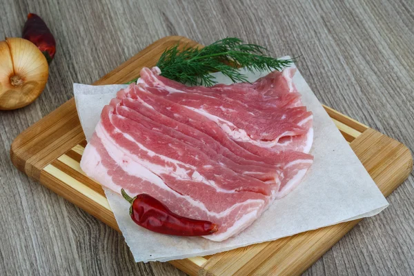 Raw bacon with dill leaves — Stock Photo, Image