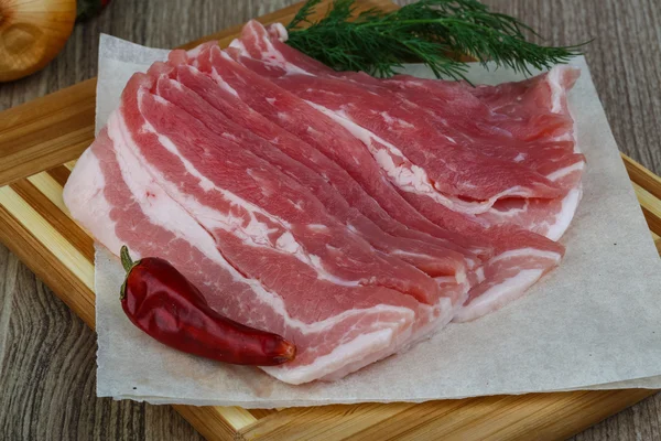 Raw bacon with dill leaves — Stock Photo, Image