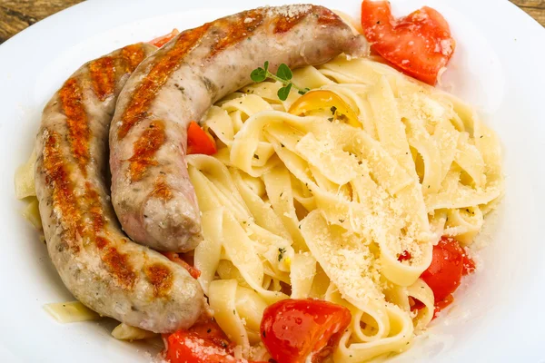 Grilled sausage with pasta — Stock Photo, Image