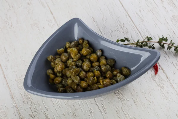 Pickled capers in bowl — Stock Photo, Image