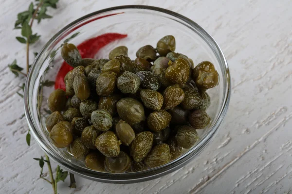 Pickled capers in the bowl — Stock Photo, Image