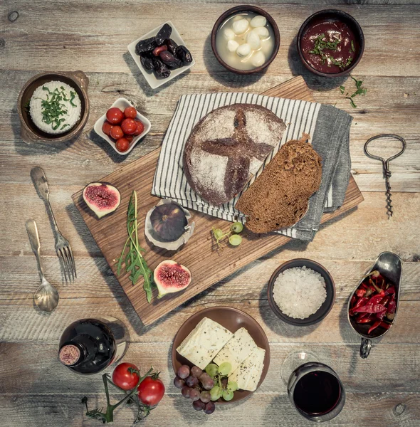 Wine with vegetables, fruits and cheeses on wooden table — Stock Photo, Image