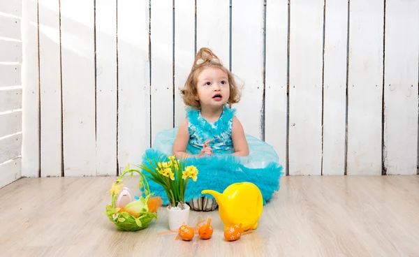 beautiful little girl on the floor with easter decorations