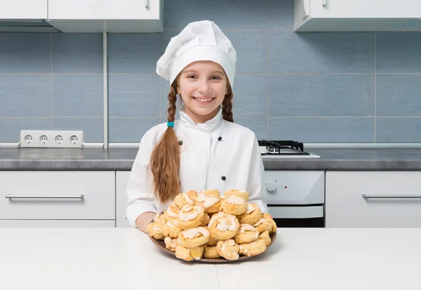 Little girl holding a bowl with homemade cookies — Stock Photo, Image