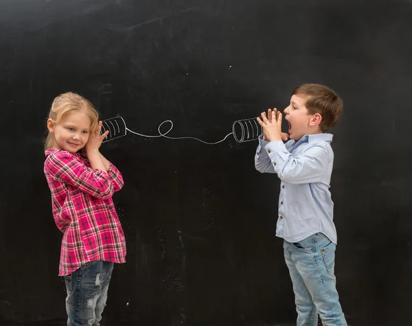 Two funny children talking on self-made drawn telephone — Stock Photo, Image