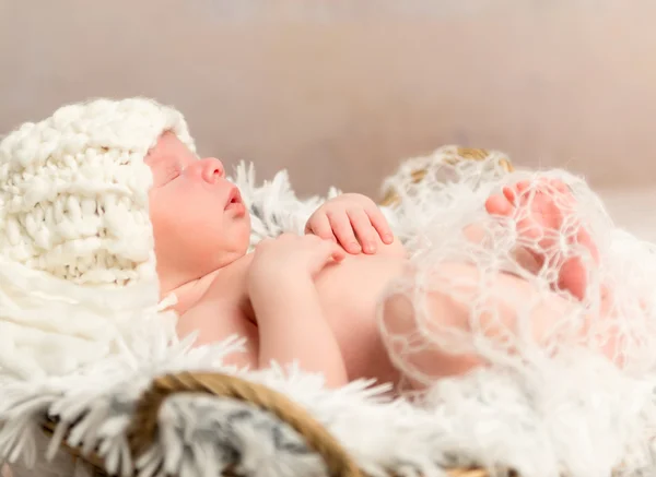 Lovely newborn baby in knitted white hat — Stock Photo, Image