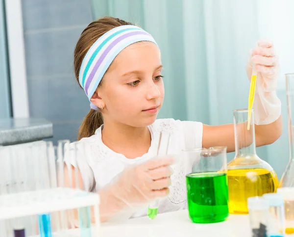 Little girl with flasks for chemistry — Stock Photo, Image