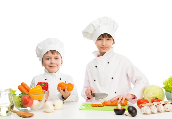 Little chefs by table with vegetables — Stock Image Little chefs by table with vegetables Stock Image