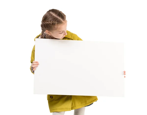 Smiling little girl with blank sheet in hands — Stock Photo, Image