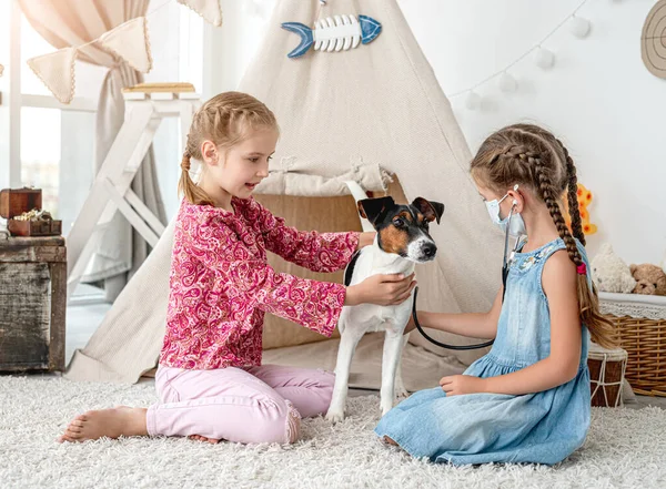 Små flickor med telefonkikare lyssnar hund — Stockfoto