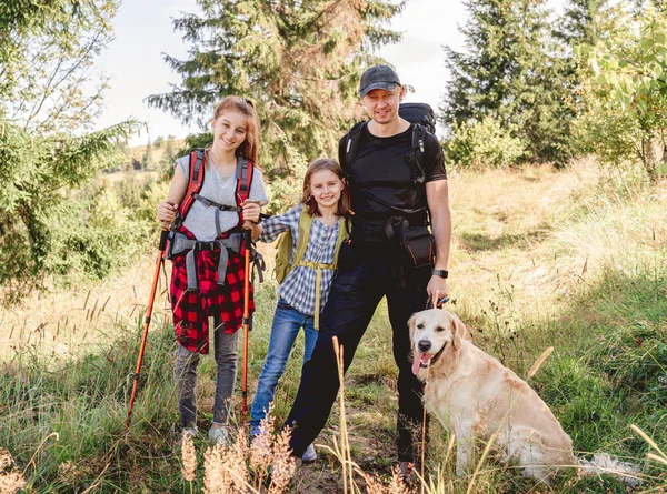 Father with daughters and dog hiking — Stock Photo, Image