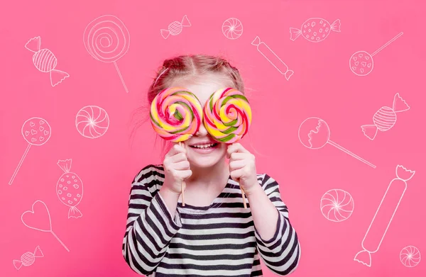 Little girl with chalk sketches of candies — Stock Photo, Image