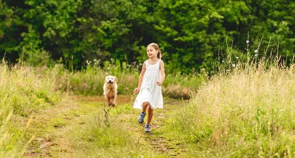 Мила маленька дівчинка біжить з собакою — стокове фото