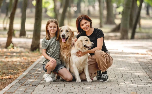Golden retriever köpeği olan anne ve kızı. — Stok fotoğraf