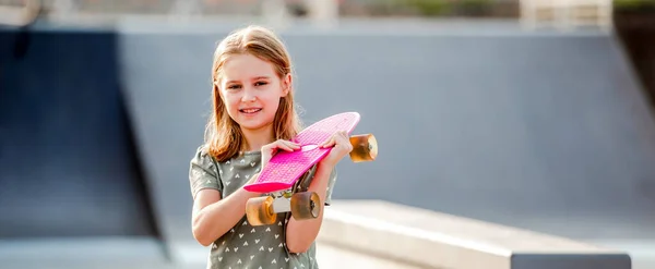 Девушка со скейтбордом на открытом воздухе — стоковое фото