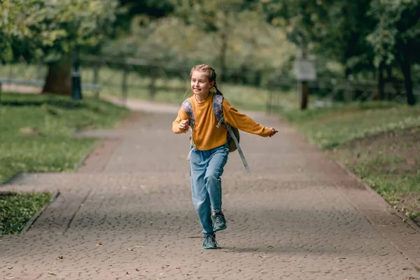 Schoolgirl with backpack outdoors — Stock Photo, Image