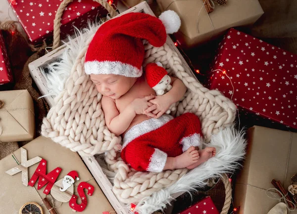 Charmig nyfödd sover mellan julklappar — Stockfoto