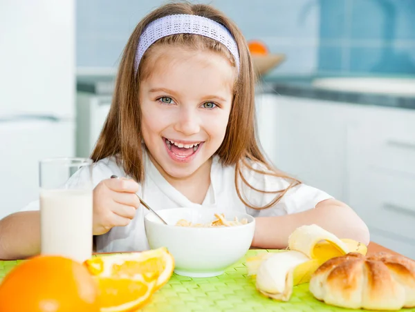 Klein meisje eten ontbijt — Stockfoto