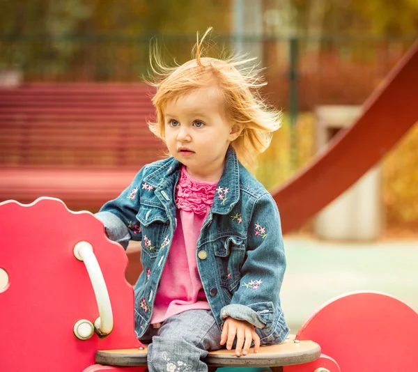 Liten flicka som leker på lekplatsen — Stockfoto