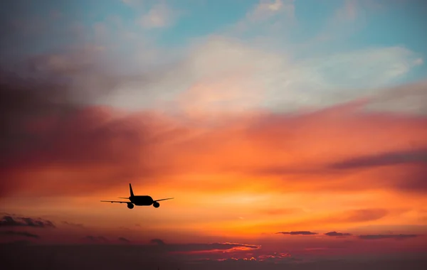 Airplane in  sky at sunset — Stock Photo, Image