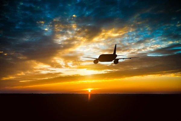 Airplane in  sky at sunset — Stock Photo, Image