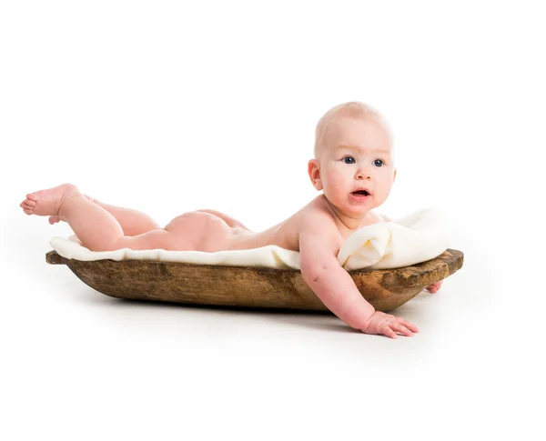 Menina bebê em cocho de madeira — Fotografia de Stock