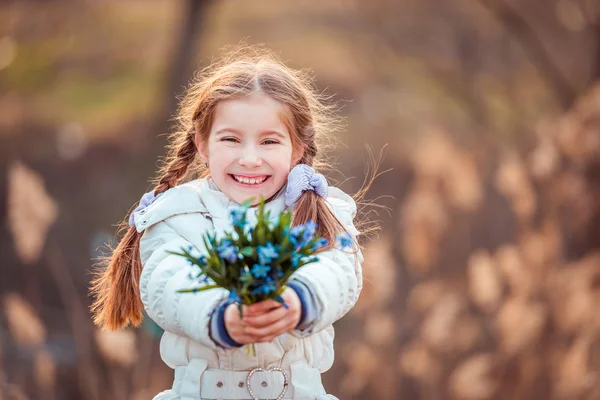 Little girl with  snowdrops — Stock Photo, Image