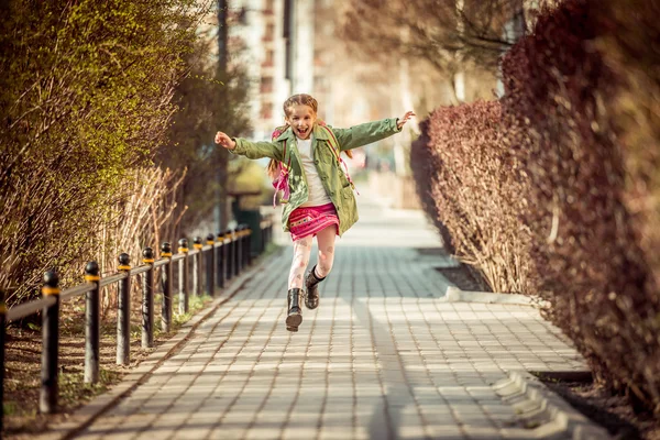 Little girl running  from school — Stock Photo, Image