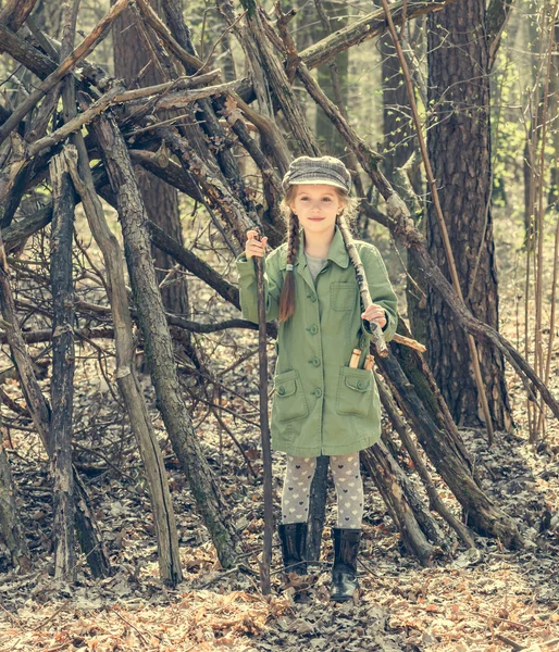 Little girl in  wood near  hut — Stock Photo, Image