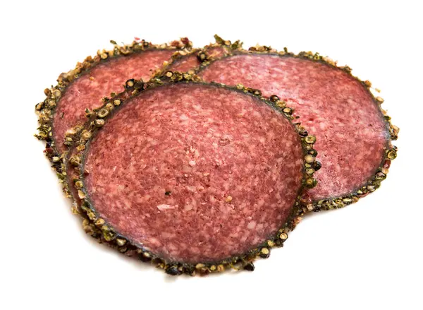 Slices of salami with spices — Stock Photo, Image