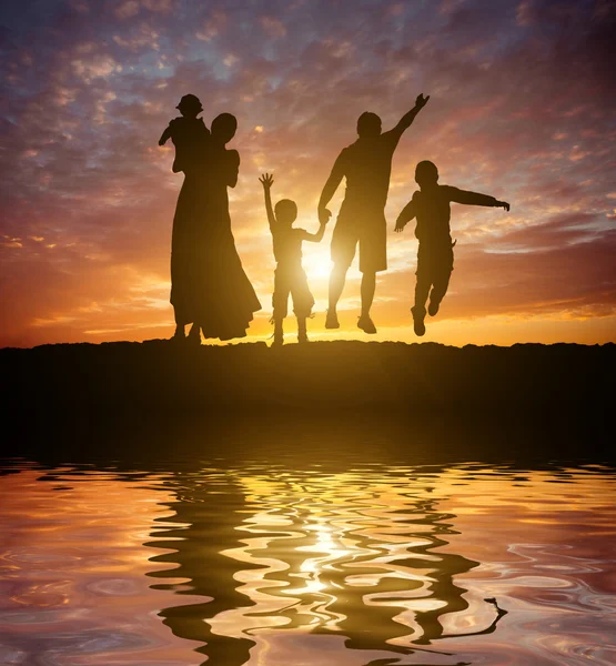 Fiery  sunset sky and family — Stock Photo, Image