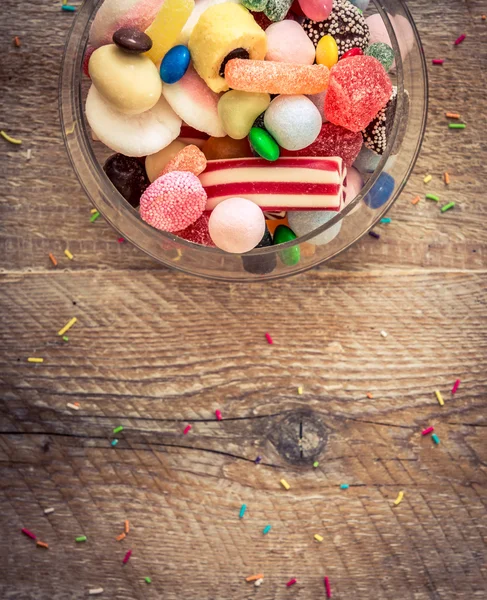 Variety of candies on wooden background — Stock Photo, Image