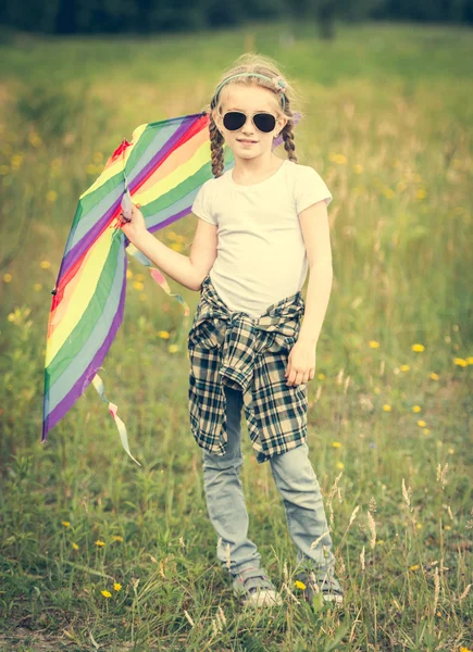 Piccola ragazza carina in posa con un aquilone — Foto Stock