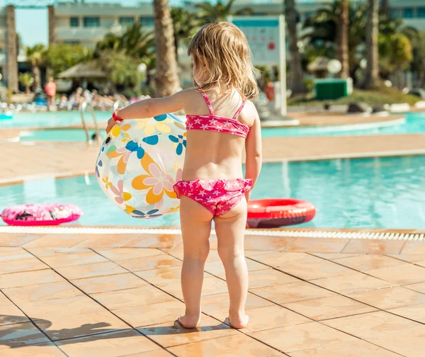 Mała dziewczynka siedzi przy basenie — Zdjęcie stockowe