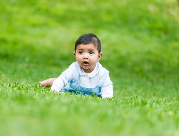 Little Spanish boy y on  grass — Stock Photo, Image