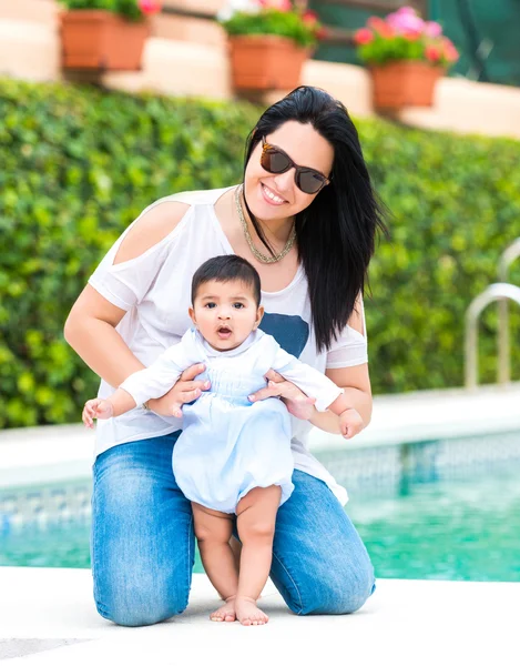 Madre con bebé cerca de la piscina — Foto de Stock