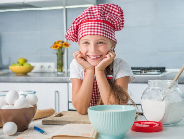 Cute little baker on kitchen — Stock Photo, Image