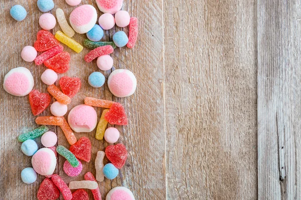 Variety of candies on a wooden background — Stock Photo, Image