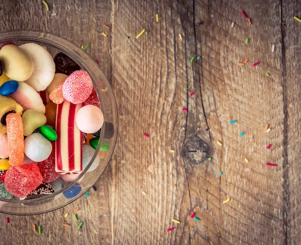 Variety of candies on a wooden background — Stock Photo, Image