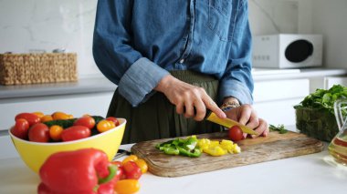 Woman Cutting Tomato For Salad