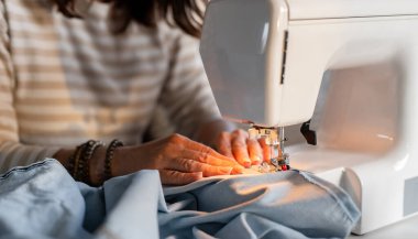 Woman's Hands Sewing On A Machine In Close-Up