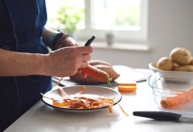 Close-Up Of A Woman Cleaning A Carrot