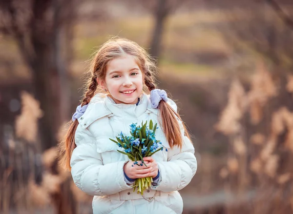 Little girl with  snowdrops — Stock Photo, Image