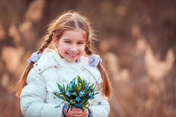 Little girl with blue  flowers — Stock Photo, Image