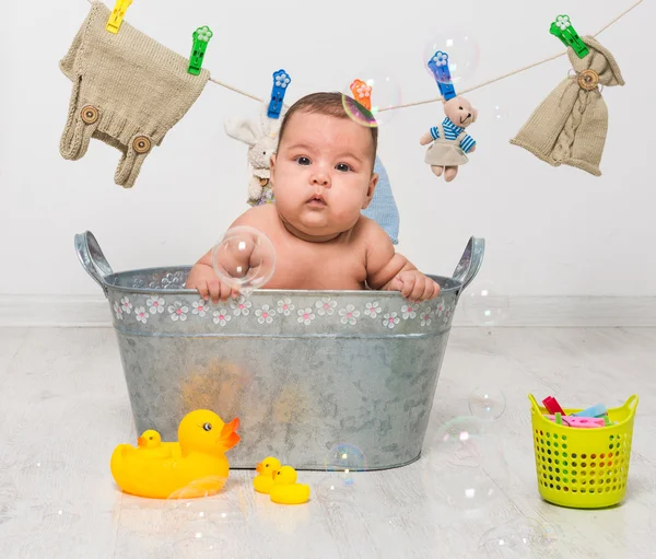 Baby girl bathes in   trough — Stock Photo, Image