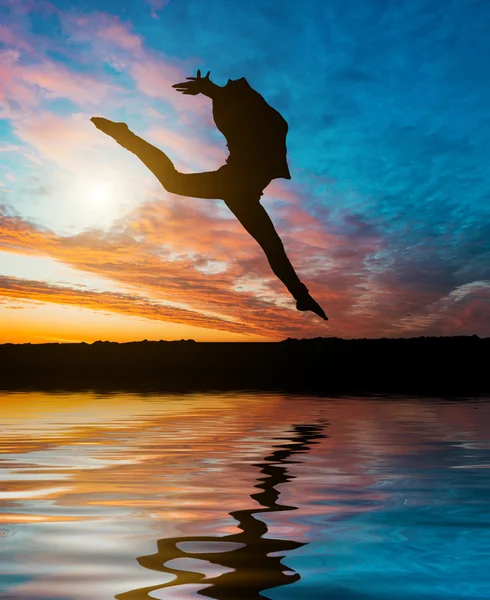 Silhouette jumping  gymnast — Stock Photo, Image