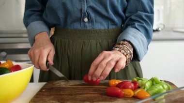 Woman Cutting Tomato For Salad