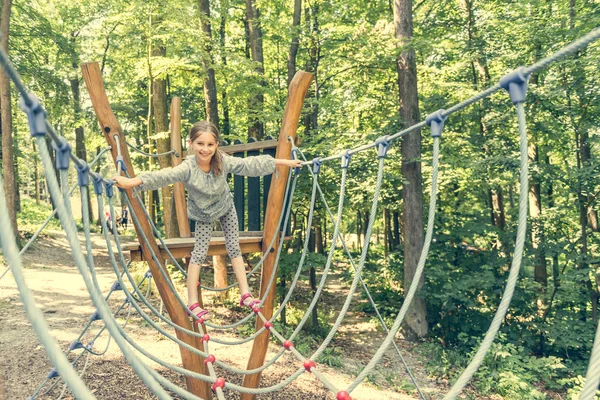 Glückliches kleines Mädchen im Seilpark — Stockfoto